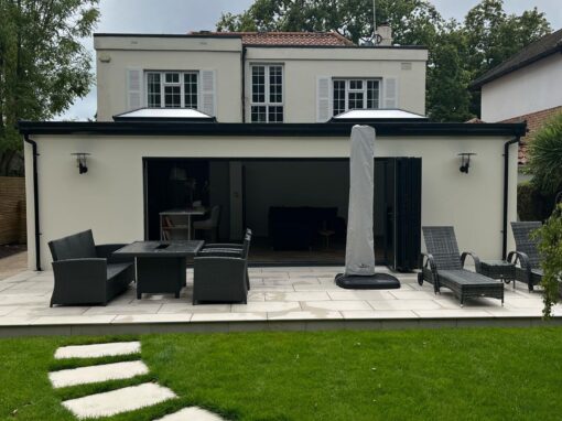 2e76d825-6380-4e0f-9381-39c9cbcfa75b-optimized Rear extension with full-width patio doors and luxury outdoor seating area.