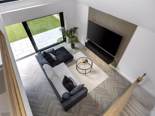 bg-hero-2 Contemporary living space with corner sofa and feature TV wall.