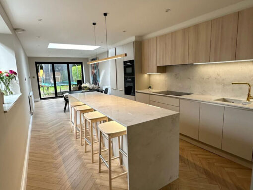 img-3-700-850 Open-plan kitchen with light wood cabinetry, skylight and breakfast island.