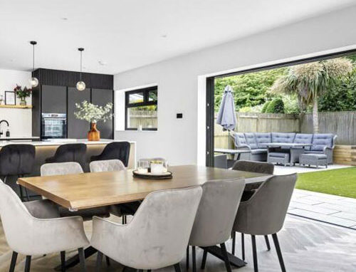 img-4-500-680 Stylish dining area with herringbone flooring and bi-fold garden doors.