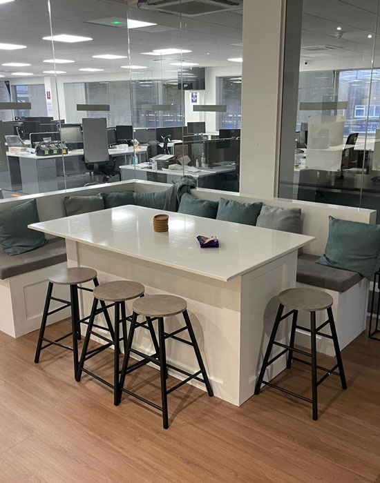 img-commercial-5 Bench-style communal workspace in a modern commercial office interior