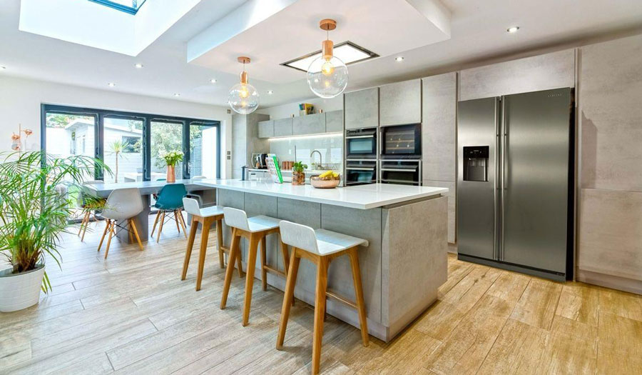 Bespoke kitchen extension featuring vaulted ceiling, skylights, and large island unit.