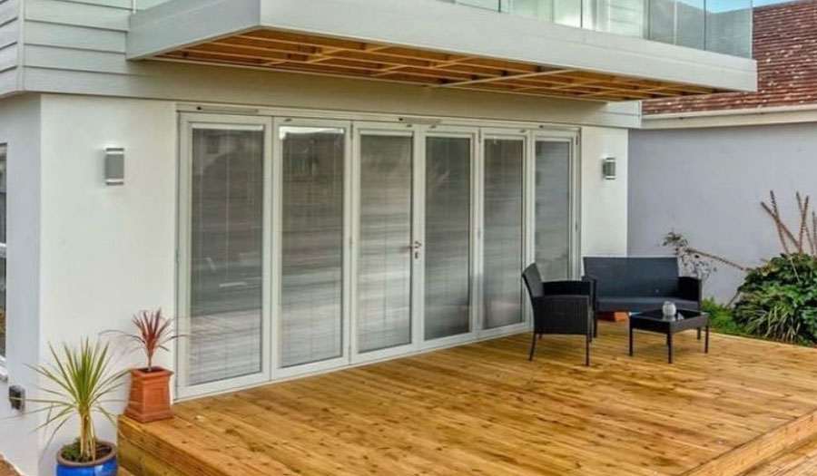 Bi-fold doors and contemporary windows enhancing natural light and garden access.
