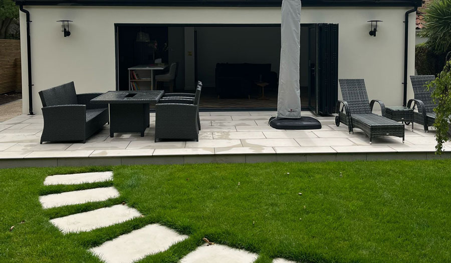 Modern garden room with patio seating area and French doors blending indoor and outdoor living.