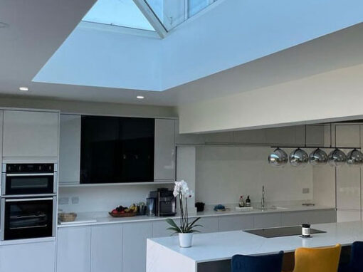 img-kitchens-550-700 Contemporary white kitchen with skylight and modern island seating.