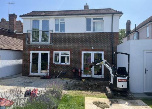 Rear extension preparation with excavation and groundwork underway in Adversane, by Sussex-based building contractor.