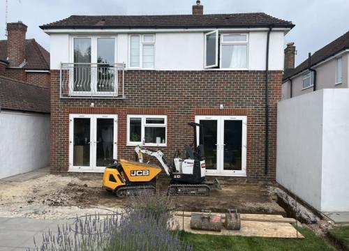 Structural groundwork and JCB digger on site for house extension project near Worthing in Adversane.