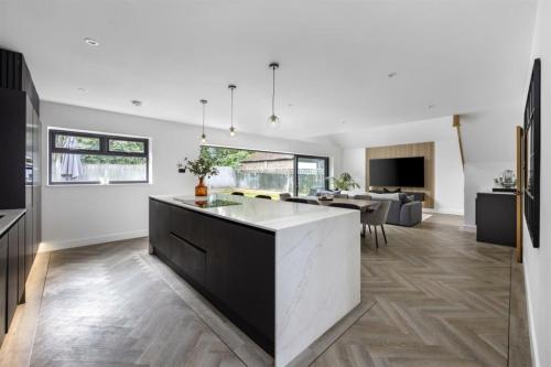 Modern kitchen island with open-plan living and garden view – part of luxury home renovation in Aldsworth, near Worthing.