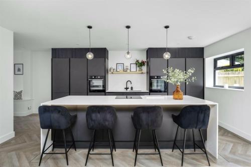 Modern kitchen island and breakfast bar in a fully renovated home near Aldsworth, West Sussex.