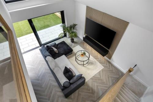 Modern living room with bi-fold doors in a completed extension project in Aldsworth, West Sussex.