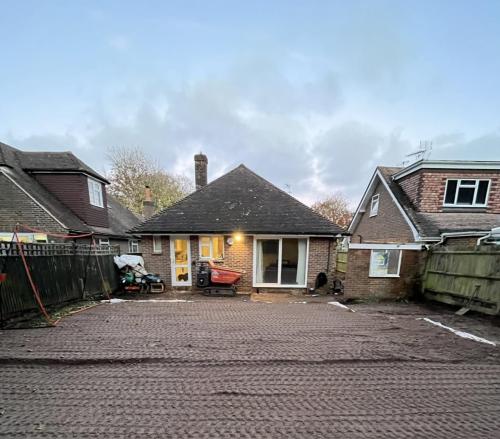 Front view of Aldsworth bungalow before renovation, showing cleared drive and preparation for home extension.