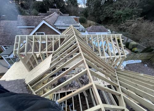 Roof truss installation on Aldsworth extension project, showing structural timber work mid-build.