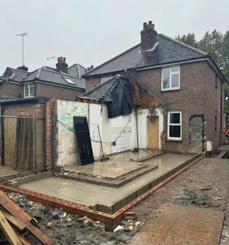 Rear of semi-detached property in Fenns Lane undergoing demolition and foundation pouring for a single-storey home extension near Worthing.