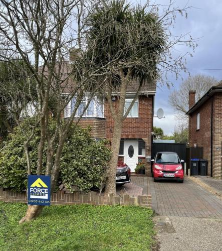 Front view of semi-detached house on Nelson Road, Worthing, with Force One Homes sign placed before major renovation.