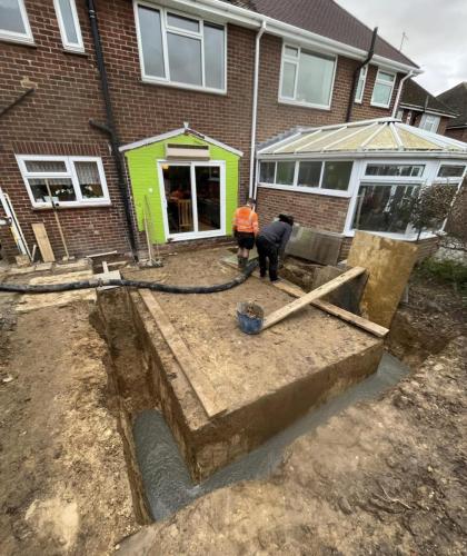 Foundation work underway for a rear home extension in Nelson Road, Worthing, with concrete pour and structural preparation by local builders.