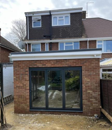 New single-storey home extension with patio and full glazing – part of a renovation project in Nelson Road, Worthing.