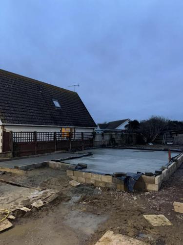 New build foundations laid for residential development in Worthing, with blockwork perimeter forming property footprint.