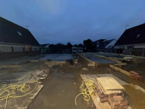 Construction site in Worthing with new blockwork walls forming the footprint of detached family homes.