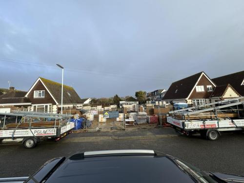 Residential street in Worthing with multiple plots under construction for detached and semi-detached new builds.