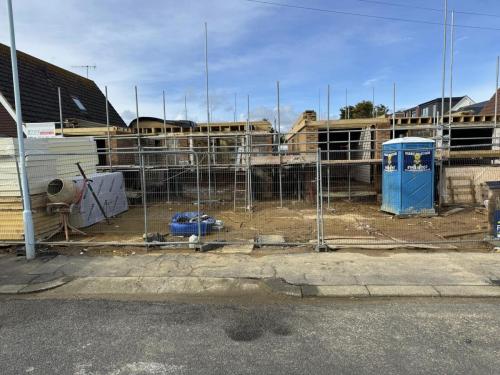 Site clearance and scaffolding preparation for new build housing plots in Worthing development area.