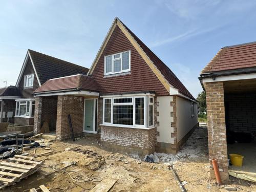 Detached new build nearing completion on North Avenue, Worthing, with rendered frontage and porch detail.
