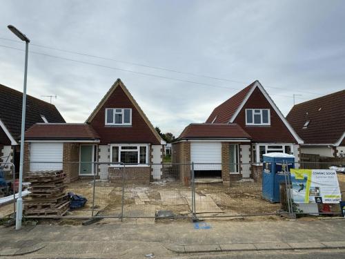 New build homes under construction on North Avenue, Worthing, with front drive preparation and external brickwork in progress.