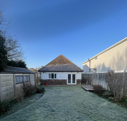 Pre-renovation rear view of Ocean Drive bungalow in Worthing before loft conversion and extension works began.