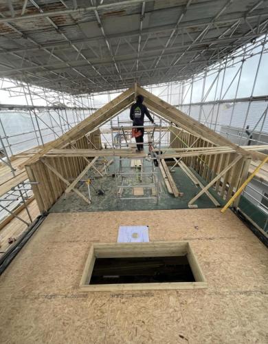 Pitched roof structure under construction at Ocean Drive renovation project in Worthing, showing loft conversion framework.
