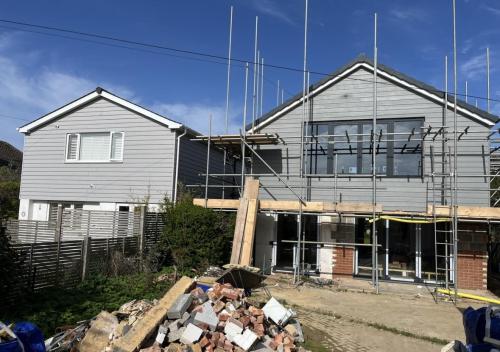 Scaffolding around double-storey home renovation in Ocean Drive, Worthing, showing full external re-cladding.