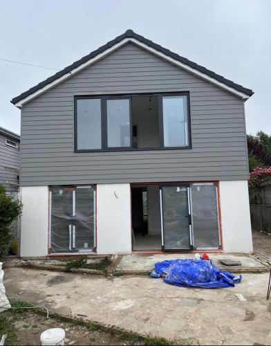 Two-storey rear extension under construction on Ocean Drive, Worthing, featuring vertical cladding and glazed doors.